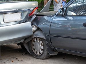 Car crash accident on street with wreck and damaged automobiles