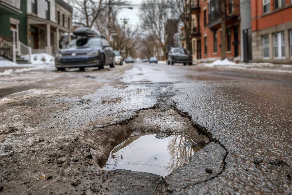 Large deep pothole in city street