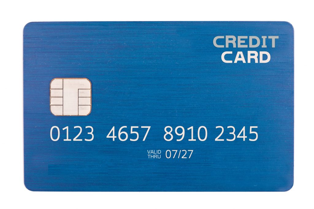 A blue credit card with numbers and the chip photographed in detail