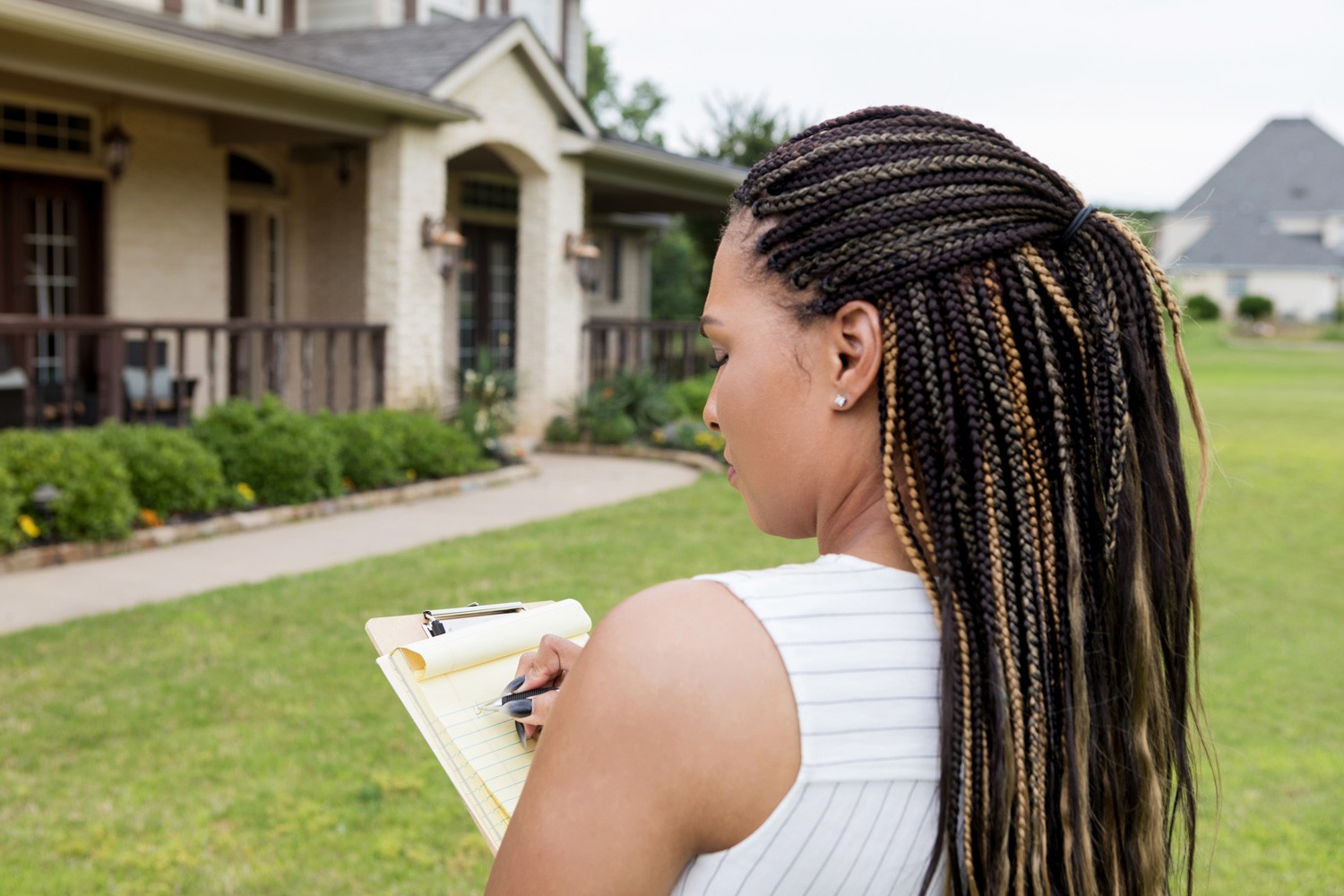 Before she puts the home on the market, the mid adult realtor evaluates the property.