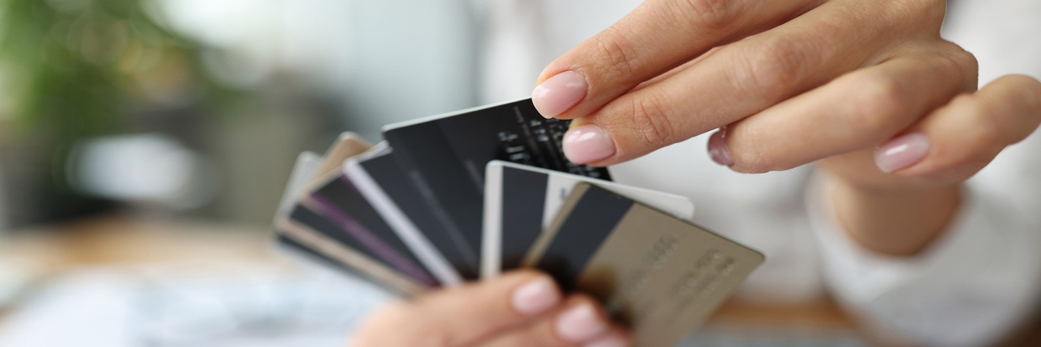 Fan of plastic credit cards is in woman's hand. Bank's favorable offers for consumers concept