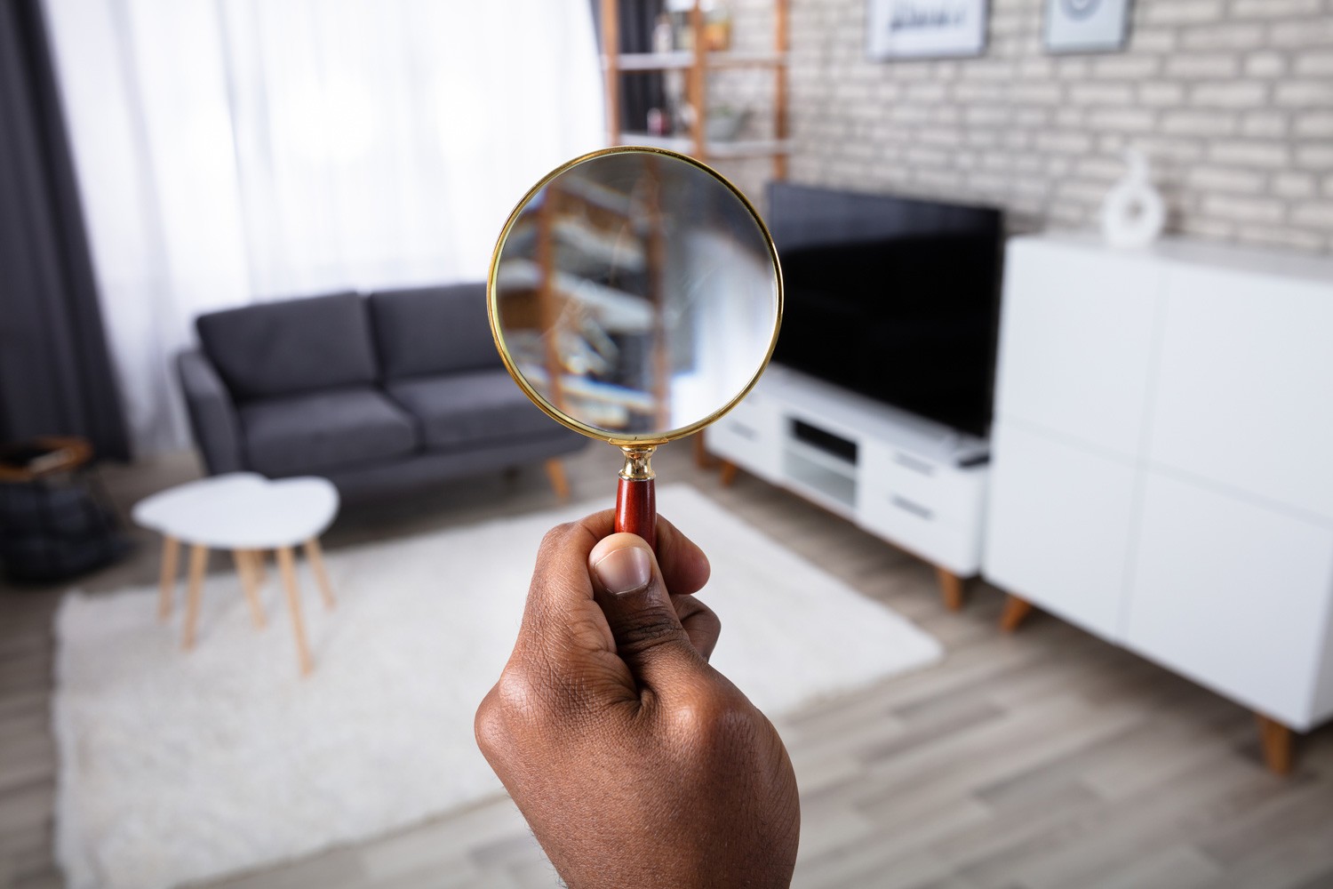 Man Searching In The House With Magnifying Glass