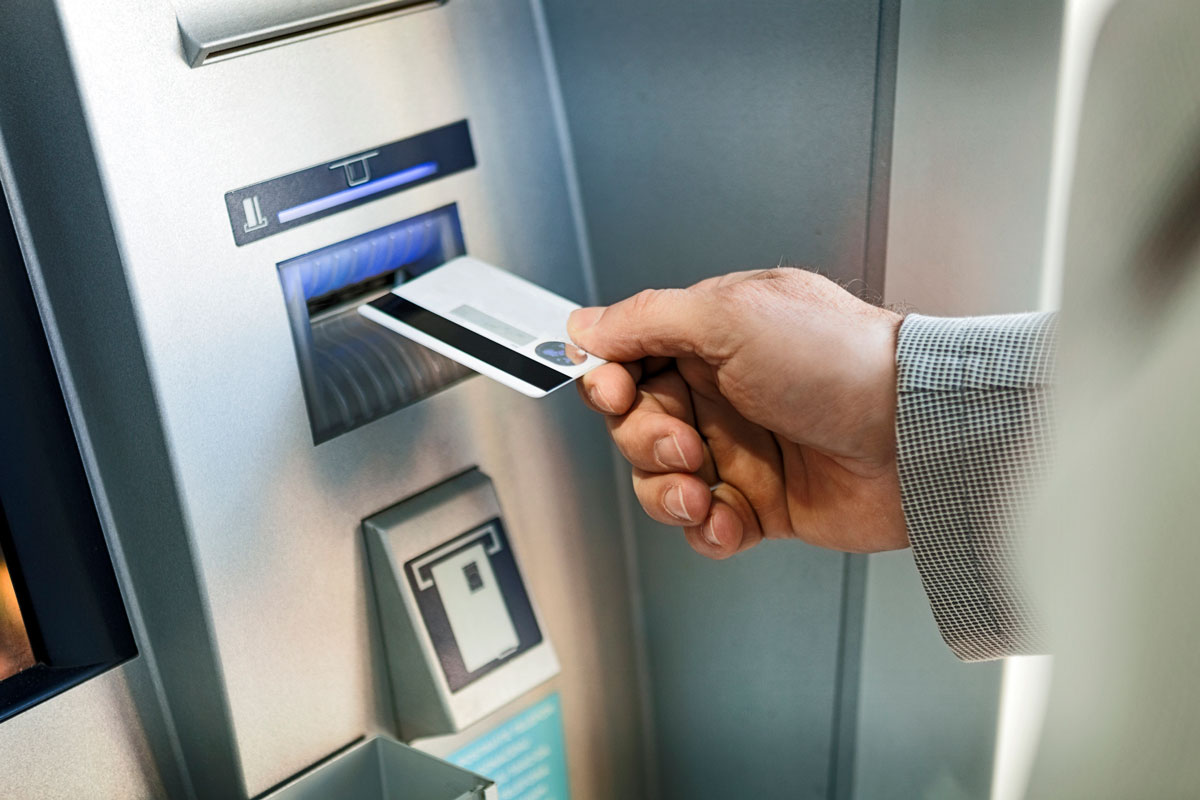 Hand inserting ATM credit card